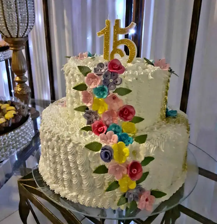 Bolo de 15 anos em andares com cascata de flores coloridas